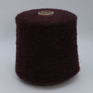 Cone of Nuage 8100 fluffy alpaca blend yarn in Dark Burgundy.