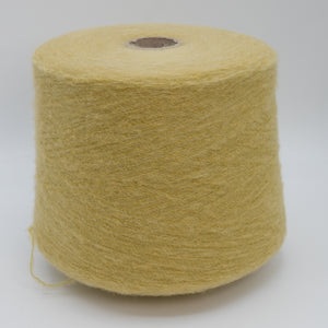 Cone of Nuage 8100 fluffy alpaca blend yarn in Mustard Cloud.