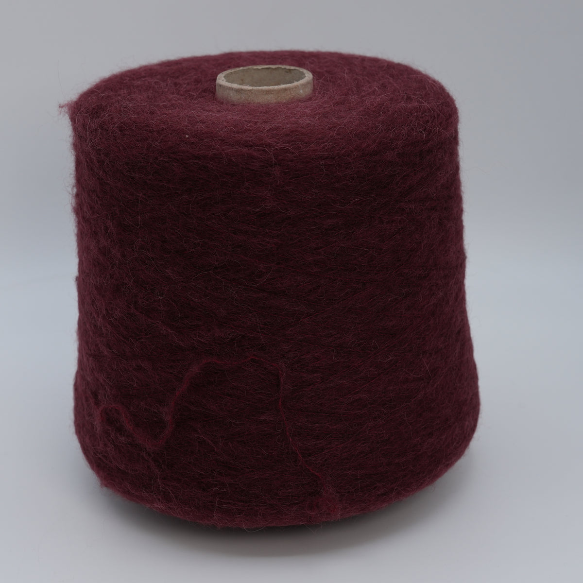 Cone of Nuage 8100 fluffy alpaca blend yarn in Cherry Bloom.
