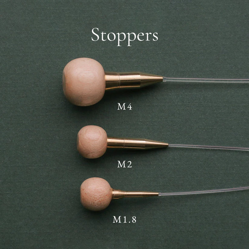 Seeknit cord stoppers