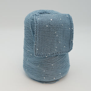 Cone and knitted swatch of Antilope 2/60 merino and sequin blend yarn in Stormy Sky.