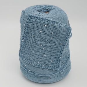 Cone and knitted swatch of Antilope 2/60 merino and sequin blend yarn in Stormy Sky.
