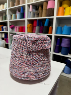 Cone and knitted swatch of BemyBaby 100% cotton yarn in Americana Twist.