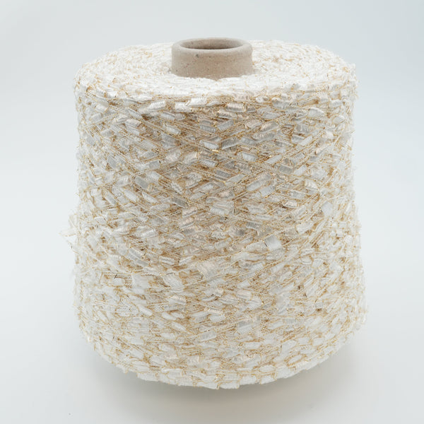 Cone of Binario polyamide and lurex blend yarn in ivory and gold.