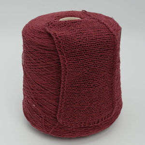 Cone and knitted swatch of Bourette Silk 4000 100% silk yarn in burgundy.
