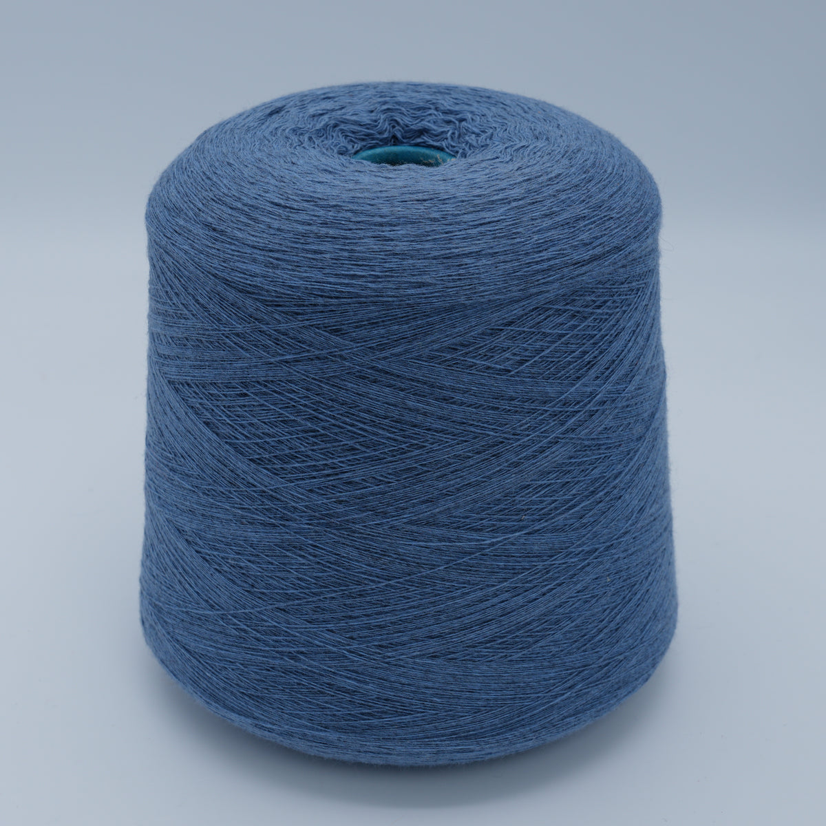 Cone of Canberra 1/15 100% lambswool merino yarn in dusty blue.