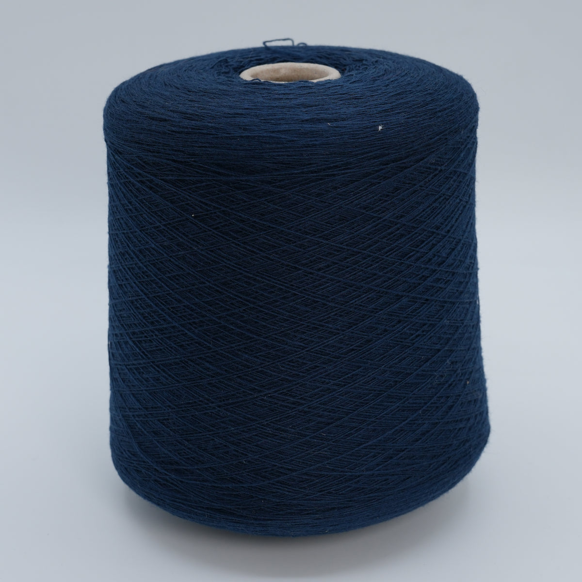 Cone of Canberra 1/15 100% lambswool merino yarn in navy blue.