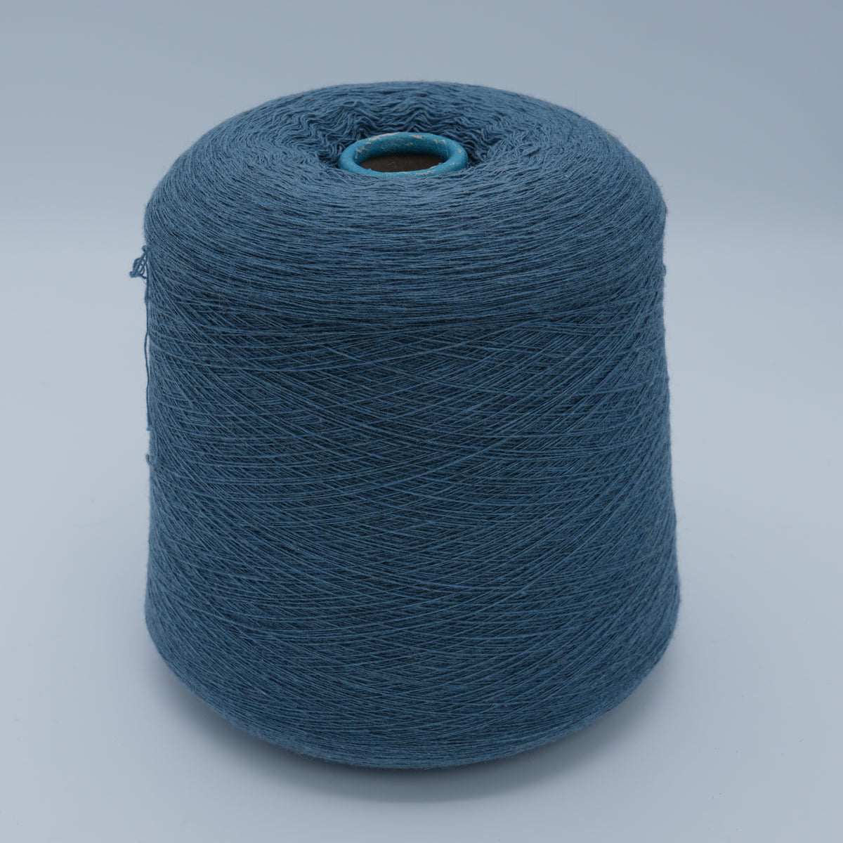 Cone of Canberra 1/15 100% lambswool merino yarn in teal blue.