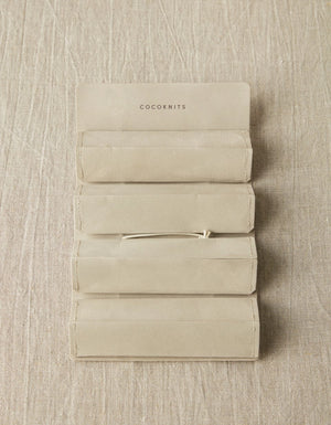 Cocoknits Accessory Roll in Gray opened flat to show four removable envelope-style storage pouches