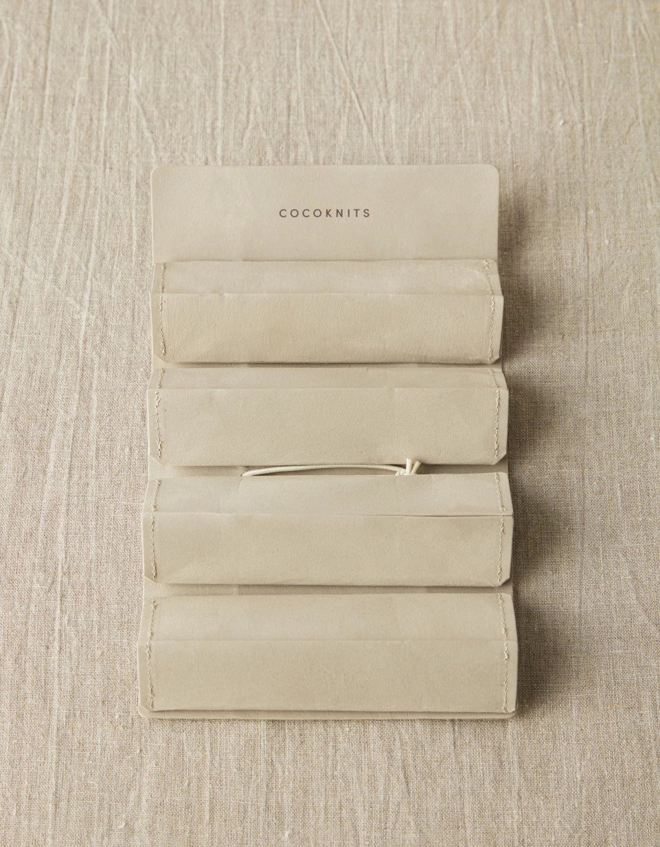 Cocoknits Accessory Roll in Gray opened flat to show four removable envelope-style storage pouches