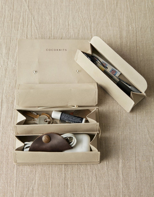 Cocoknits Accessory Roll in Gray opened to show removable pouches filled with knitting tools and small craft accessories