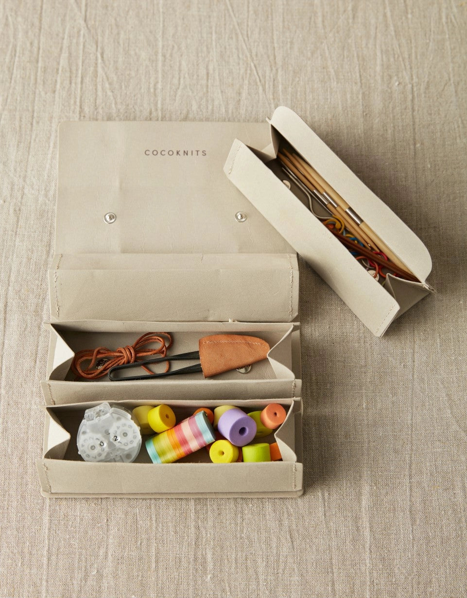 Cocoknits Accessory Roll in Gray with removable triangular storage pouches holding colorful knitting notions