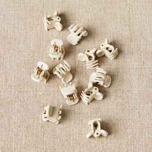 Close up of Cocoknits biodegradable PLA Claw Clips designed to grip knitted fabric without damaging fibers