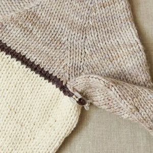 Cocoknits Claw Clip securing two knitted garment sections together during sweater assembly