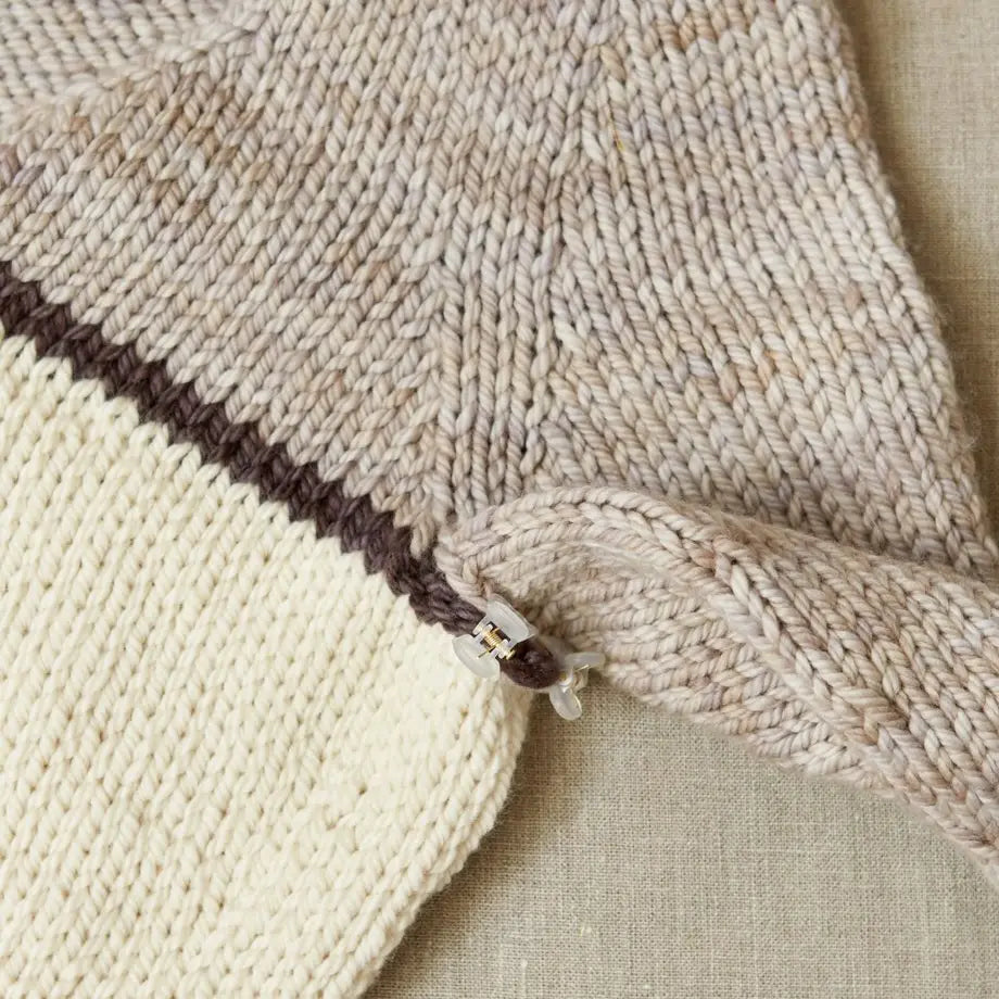 Cocoknits Claw Clip securing two knitted garment sections together during sweater assembly