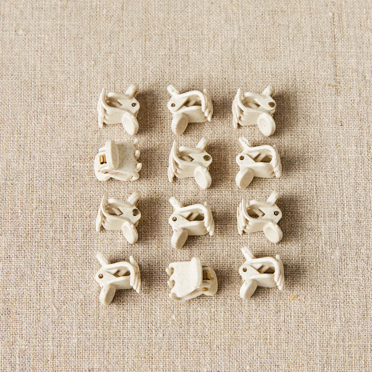 Set of 12 Cocoknits Claw Clips arranged together for seaming, blocking, and garment construction