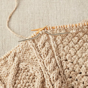 Cocoknits Curved Cable Needle in use while knitting a textured cable pattern