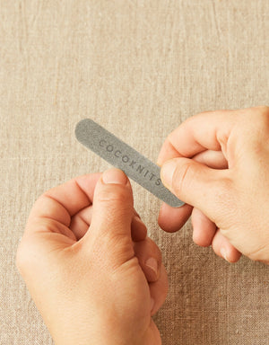 Cocoknits Emery Board compact nail care tool held in hand for smoothing rough edges