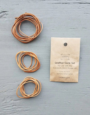 Cocoknits Extra Leather Cords arranged beside their kraft paper packaging