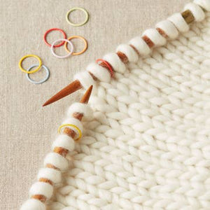 Cocoknits Jumbo Ring Stitch Markers on a knitting needle showing their oversized design