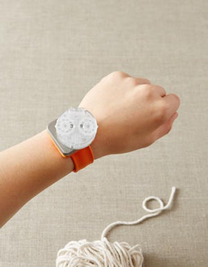 Cocoknits Knitting Row Counter attached to a Maker's Keep magnetic wristband while knitting