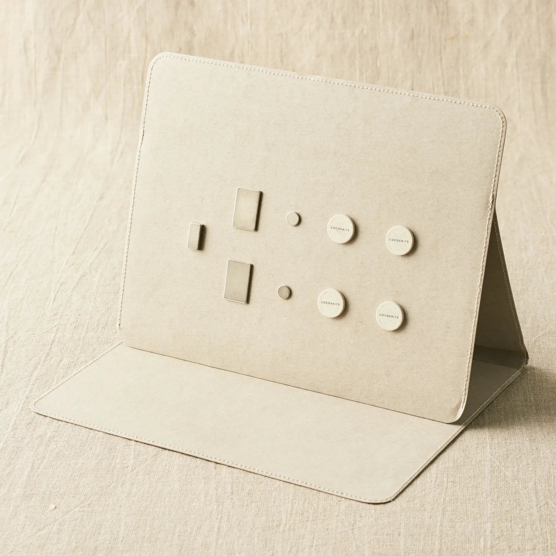 Cocoknits Maker's Board in Gray standing open with included magnets and magnetic tools