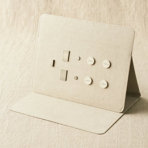 Cocoknits Maker's Board in Gray standing open with included magnets and magnetic tools