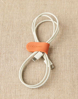 Cocoknits Maker's Clip in Orange organizing a coiled cord
