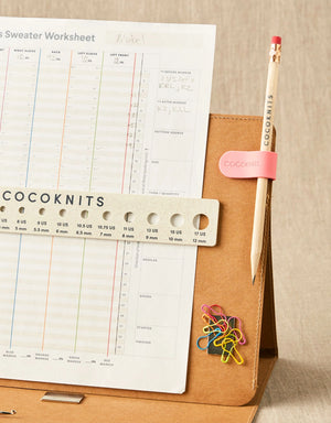Cocoknits Maker's Clip in Rose organizing a knitting pattern and small notions