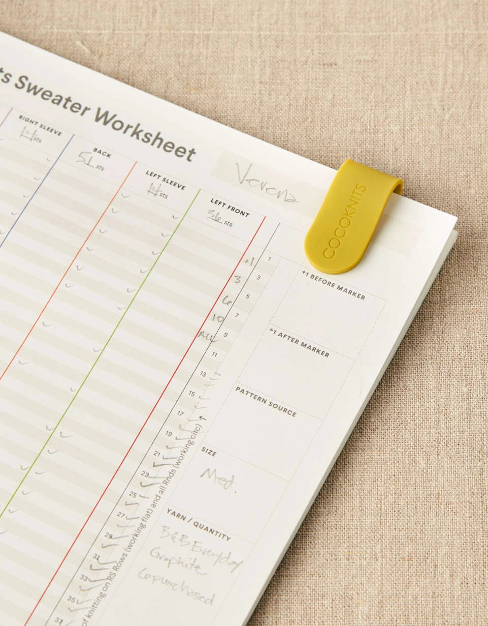 Cocoknits Maker's Clip in Yellow holding knitting pages