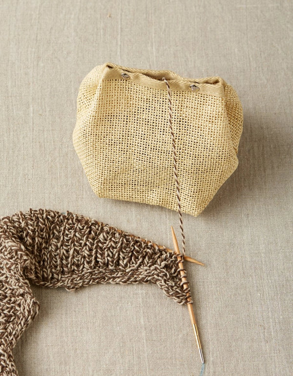 Cocoknits Natural Mesh Bag holding yarn with a knitting project beside it