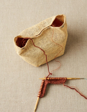 Cocoknits Natural Mesh Bag holding yarn for a red knitting project