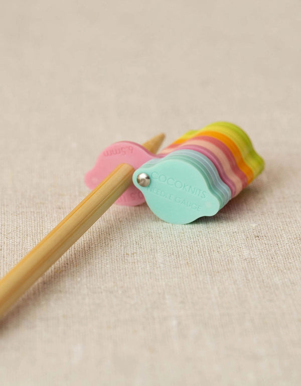 Cocoknits Needle Gauge with colorful magnetic discs on a wooden knitting needle