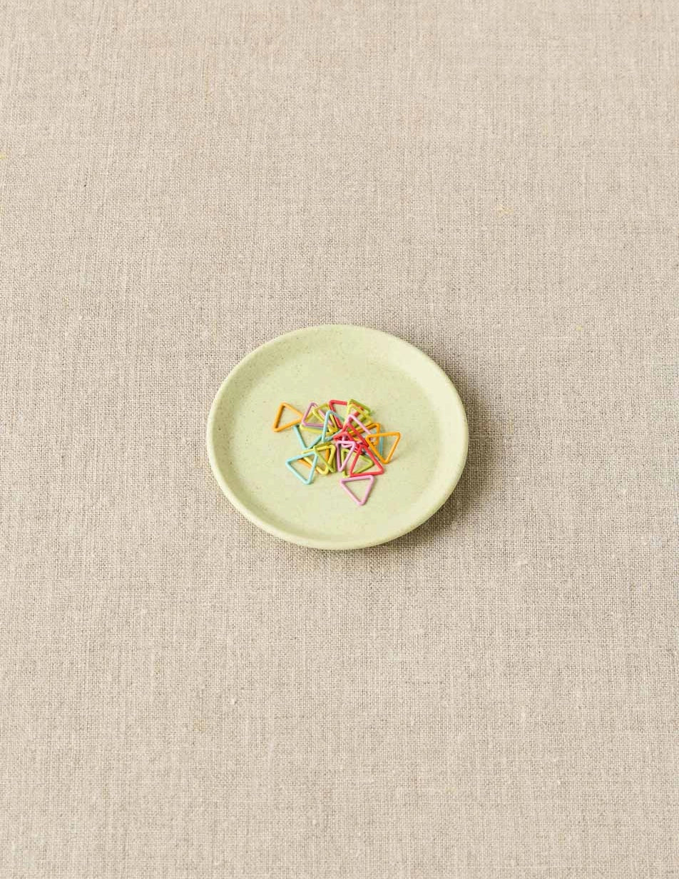 Cocoknits Notions Dish in Celery holding colorful stitch markers
