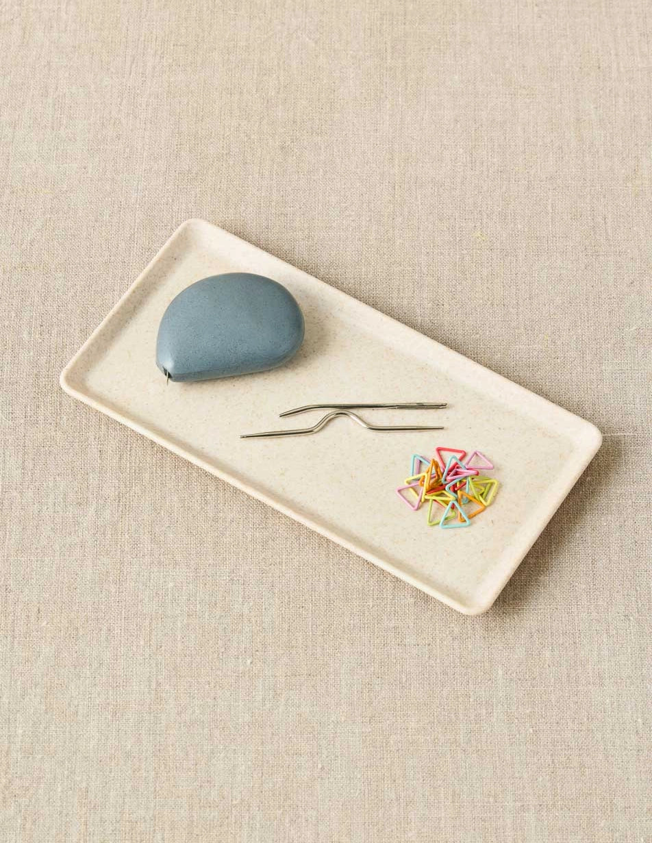 Cocoknits Notions Dish in Linen with stitch markers and small knitting tools