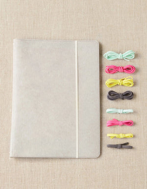 Cocoknits Project Portfolio with colorful stitch holders on a beige linen background