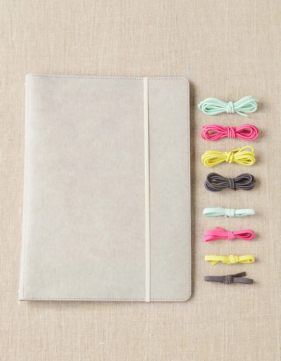 Cocoknits Project Portfolio with colorful stitch holders on a beige linen background