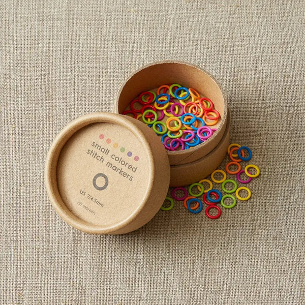 Cocoknits Small Stitch Markers set of 60 in six bright colors displayed in an open round storage container