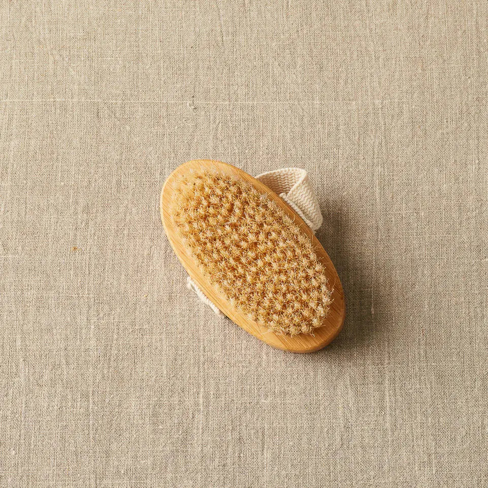 Cocoknits Sweater Care Brush. Oval wooden brush showing its bristles.