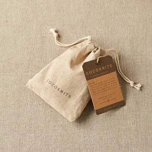 Cocoknits Sweater Care Brush. Fabric storage bag and branded tag for the sweater care brush.
