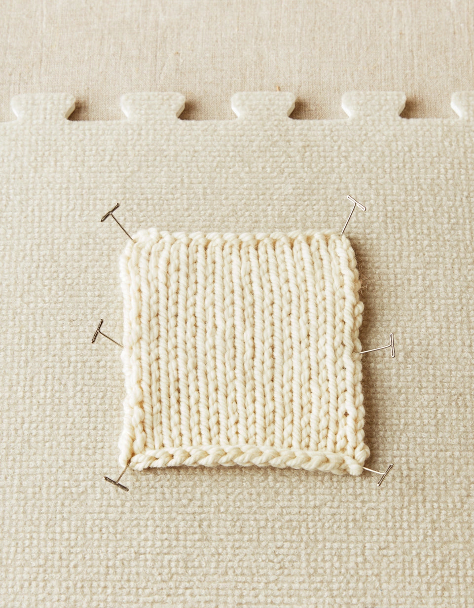 Cocoknits T-Pins. Knitted swatch secured with T-pins on a blocking mat.