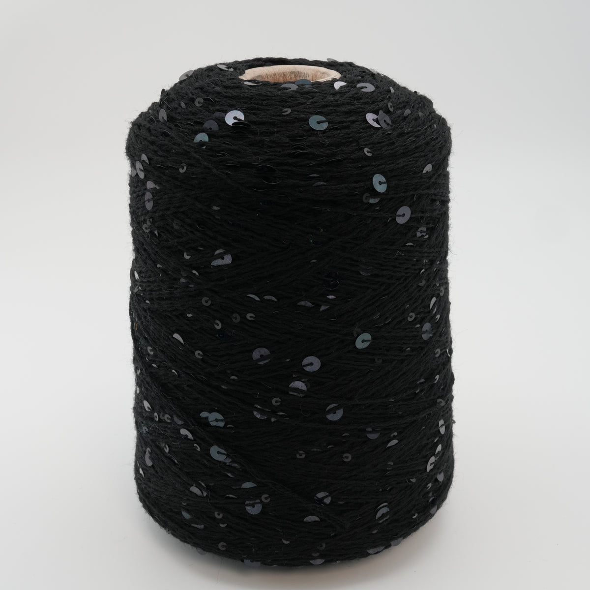 Cone of Cosmo two-size paillette 100% merino yarn in black.