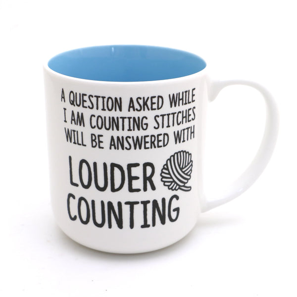 Counting Stitches Mug. White mug with a blue interior and counting-stitches slogan.