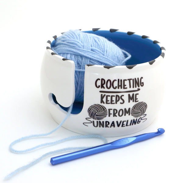 Crochet Keeps Me from Unraveling Yarn Bowl. White bowl with a blue interior, holding blue yarn beside a crochet hook.