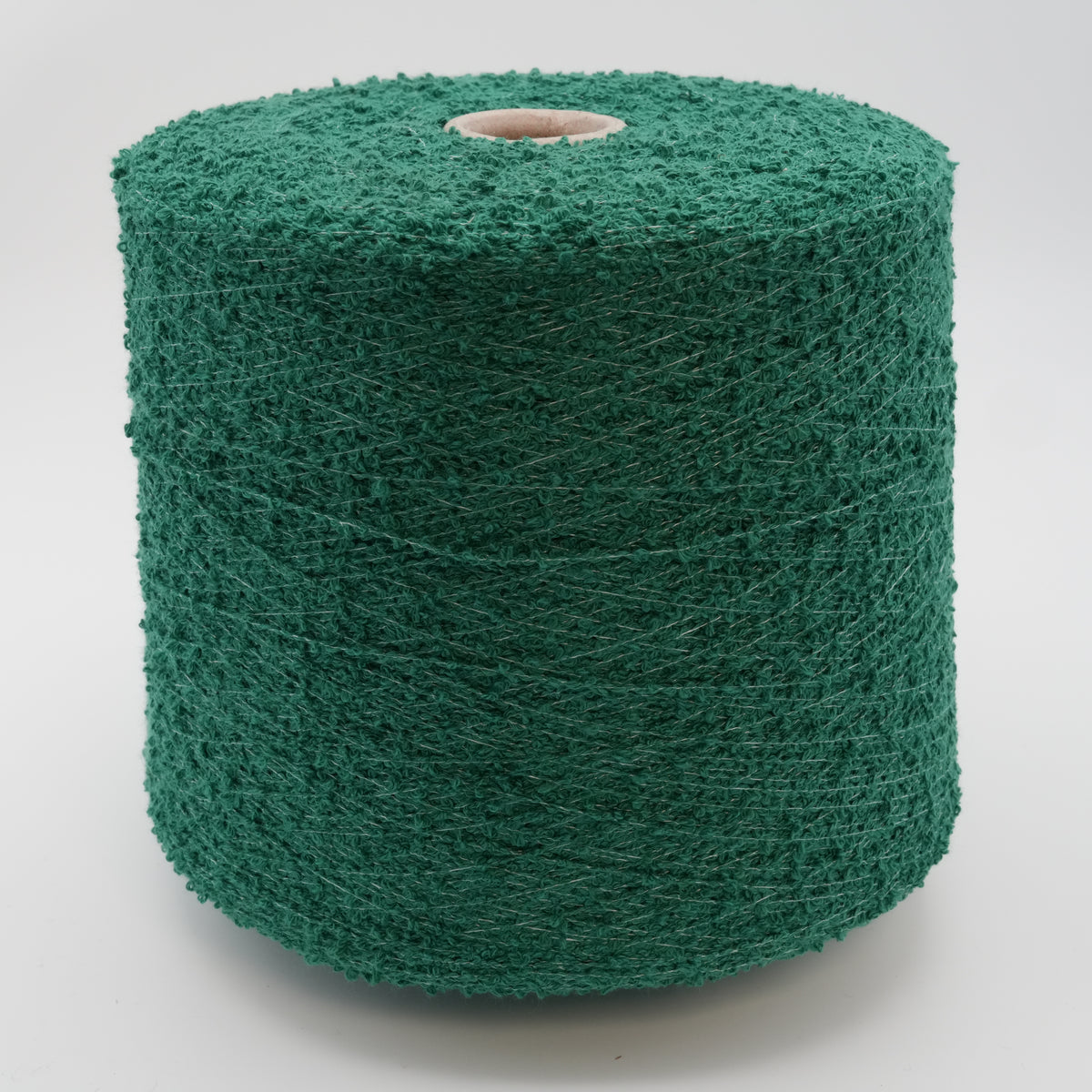 Cone of Curly bouclé cotton and polyamide blend yarn in emerald green.
