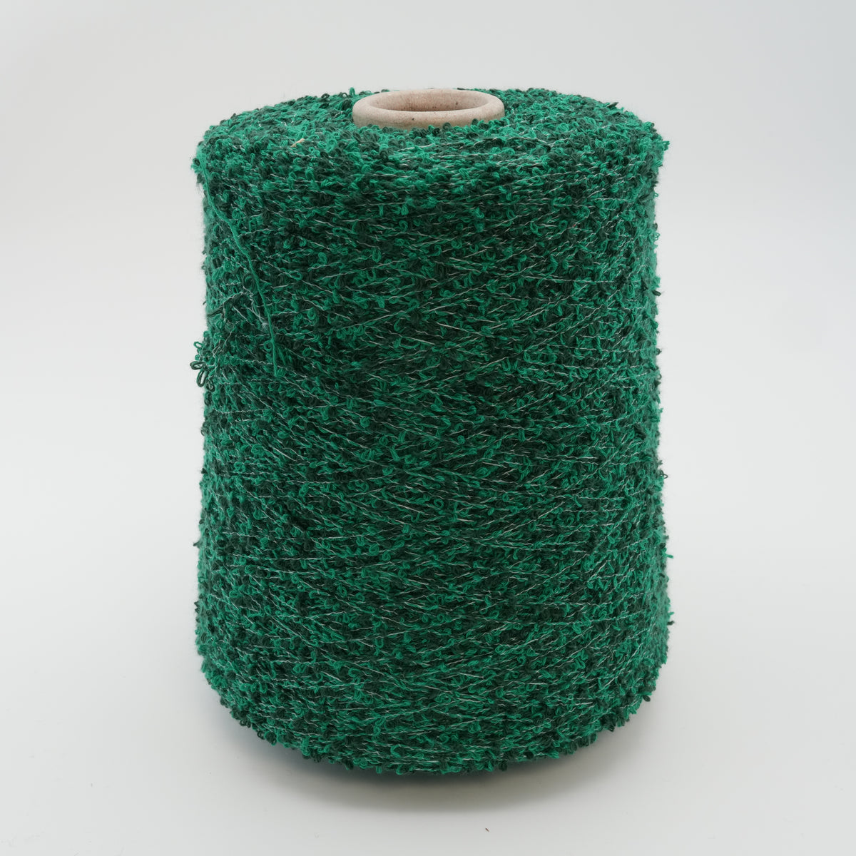 Cone of Curly bouclé cotton and polyamide blend yarn in Green on Black.