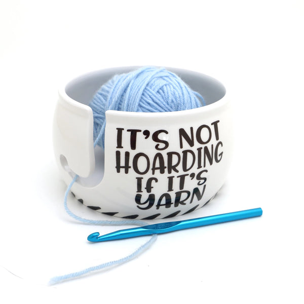 Hoarding Yarn - Yarn Bowl. White yarn bowl holding blue yarn beside a crochet hook.
