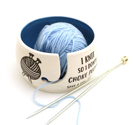 I Knit So Don't Choke People Yarn Bowl. Cream-colored bowl with a blue interior, holding blue yarn.