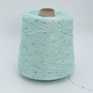 Cone of Lino 4200 linen yarn in Mint Sequin, pale mint green with scattered blue sequins, on a white background.