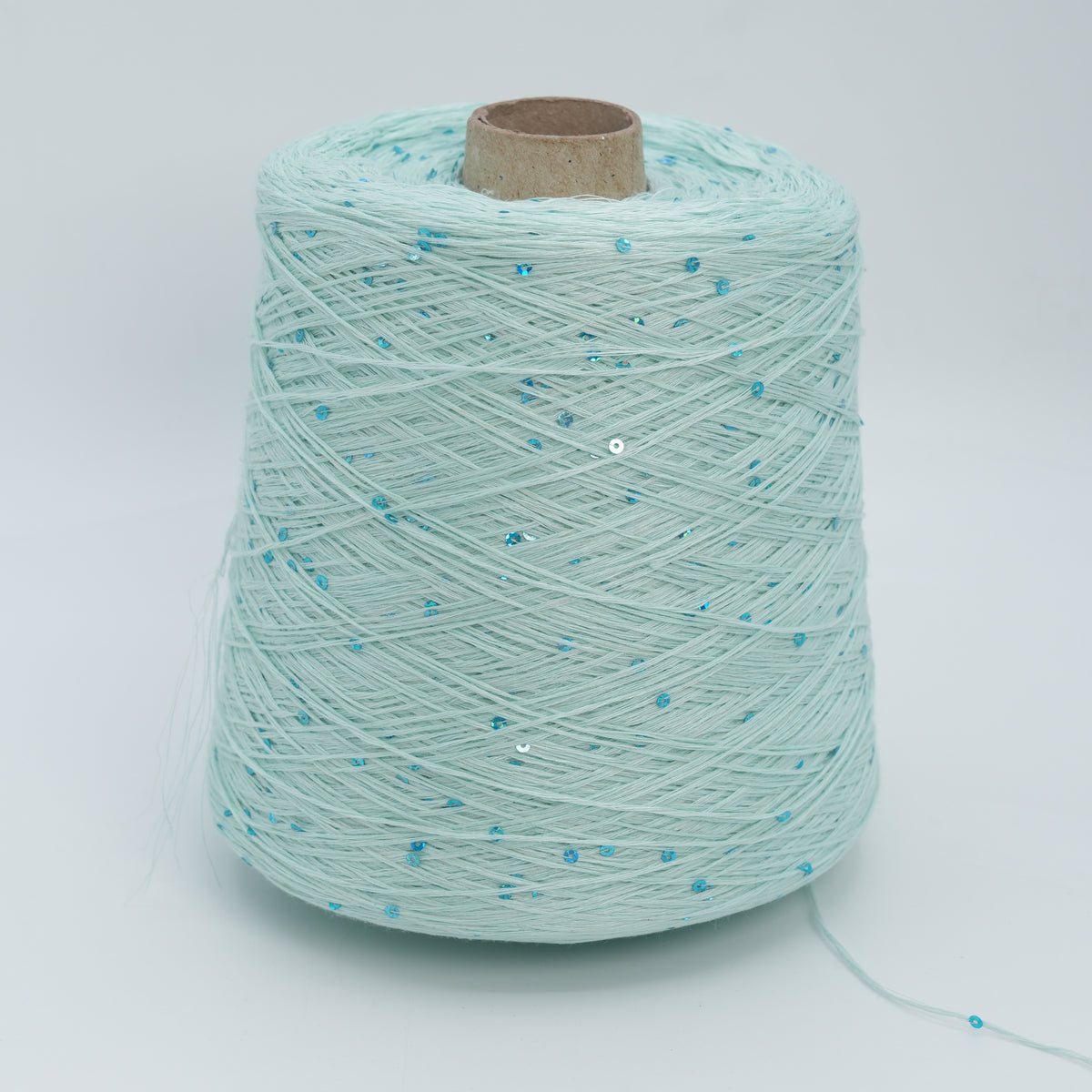 Cone of Lino 4200 linen yarn in Mint Sequin, pale mint green with scattered blue sequins, on a white background.